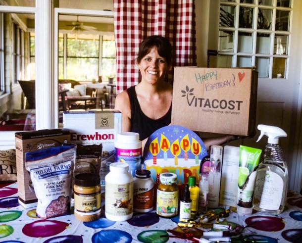 lots of Vitacost products on a table with Birthday decorations
